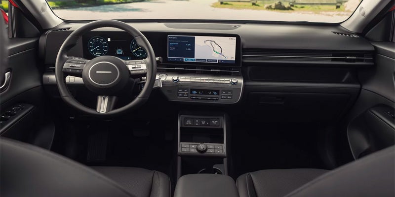 Hyundai Kona interior with digital dashboard, steering wheel, and infotainment display.