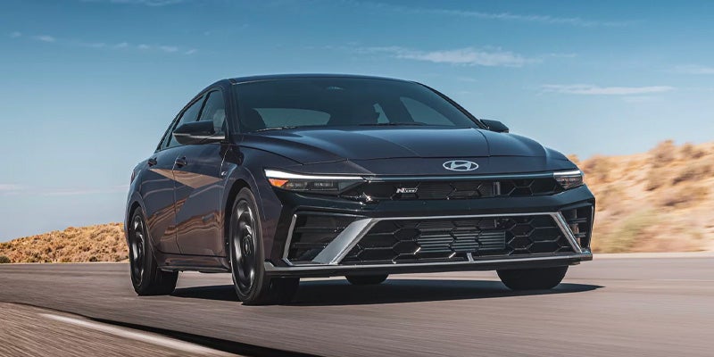 2026 Hyundai Elantra N Line sedan driving on scenic road