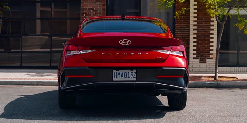 2026 Hyundai Elantra red sedan rear view on city street