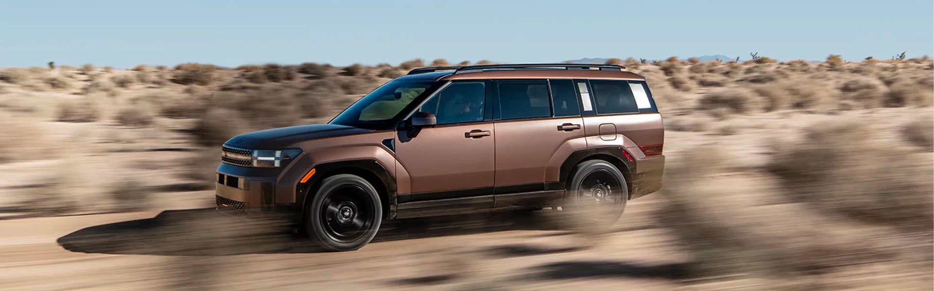 2026 Hyundai Santa Fe SUV driving through desert terrain