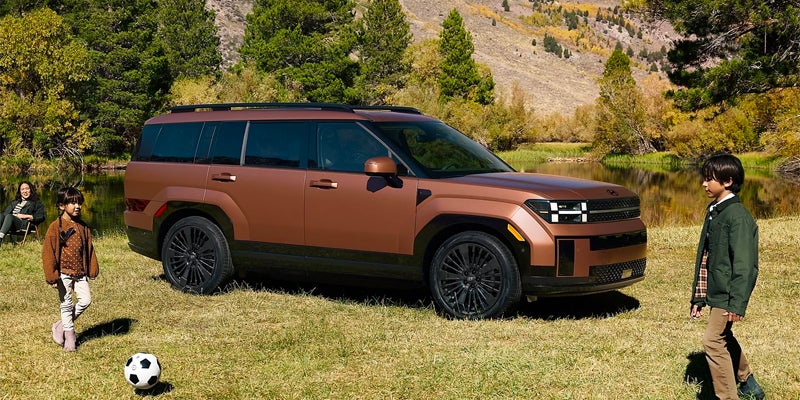 2026 Hyundai Santa Fe XRT SUV parked on grassy outdoor terrain