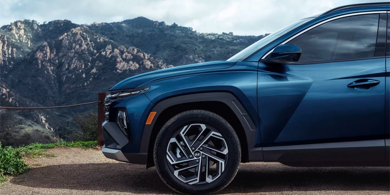 Hyundai Tucson side profile showcasing alloy wheels and sleek exterior design.
