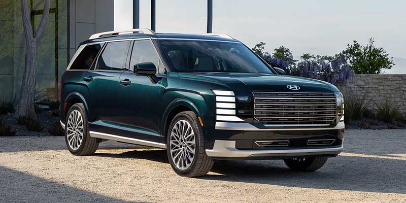 Green Hyundai Palisade SUV parked outdoors with modern styling and premium design.