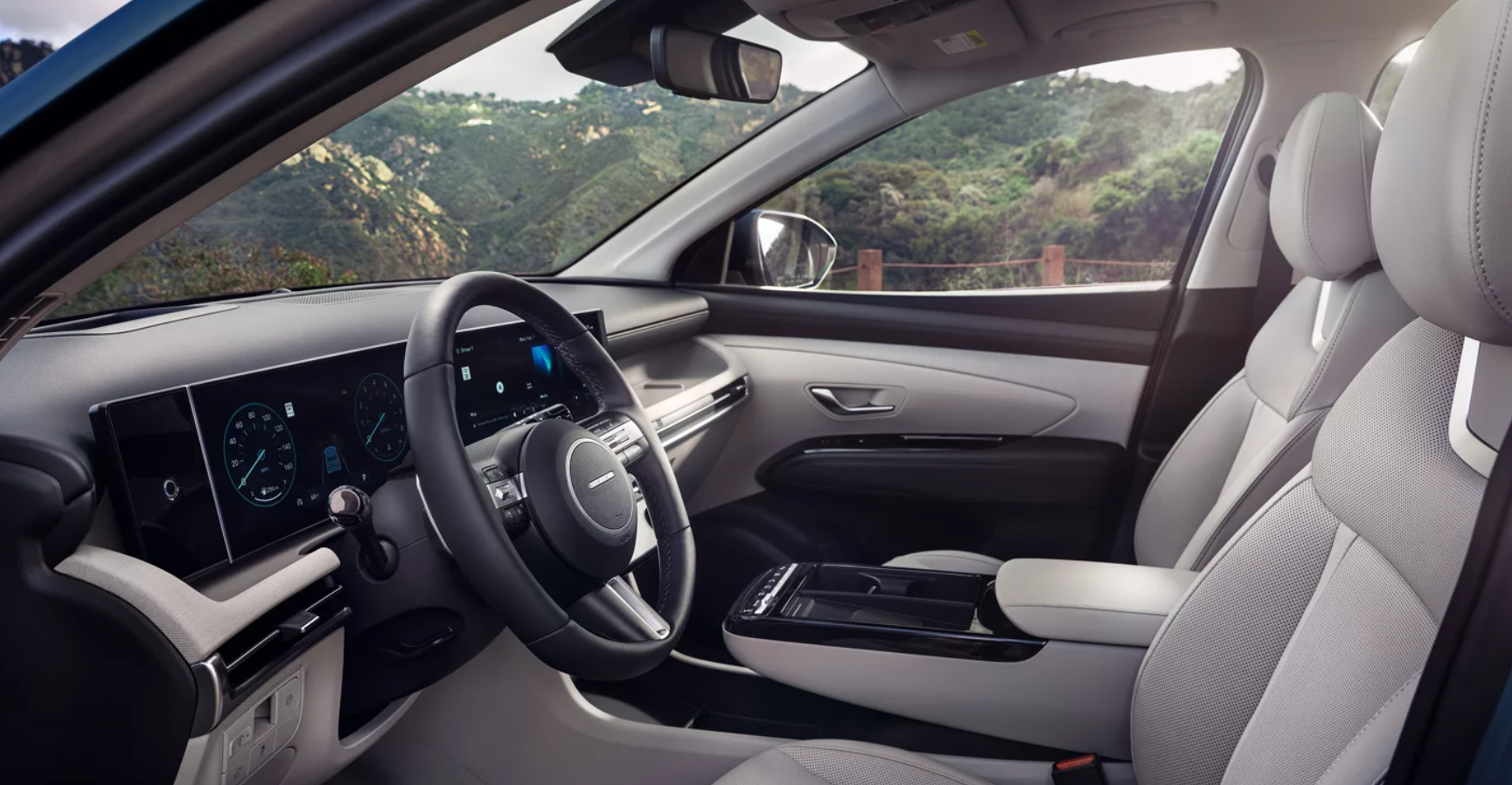 2026 Hyundai Tucson interior with digital displays and light gray seating.